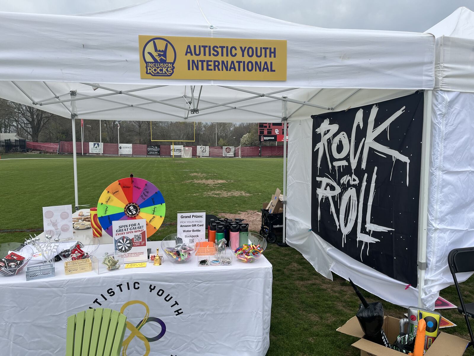 Autistic Youth International tent with activity table at a festival