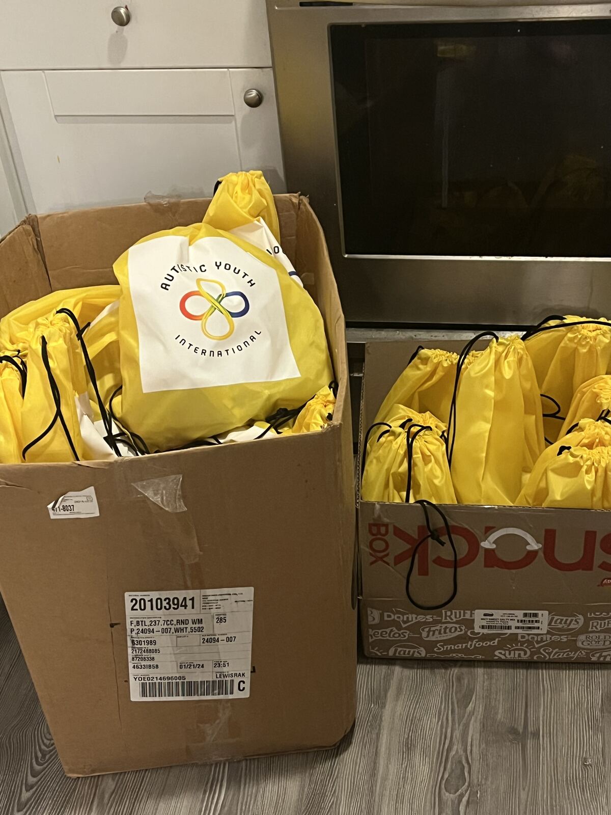 Yellow AYI tote bags packed for donation