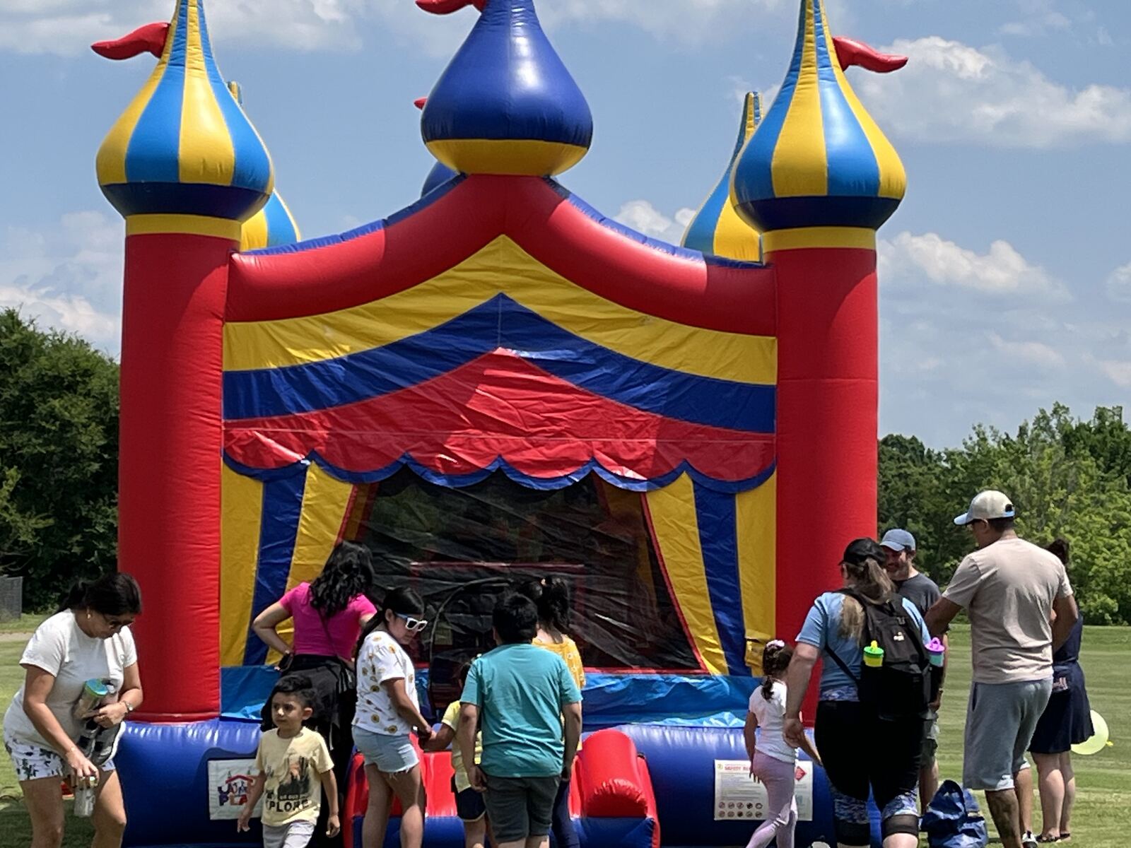 Children playing at a bounce house during a community event